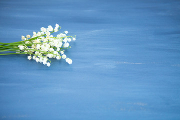 Wonderful fragrant white flowers with a delicate scent. Lily of the valley flowers on gray wooden or metal table