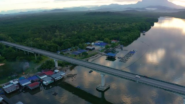 Aerial footage of Beautiful Rural village landscape with green forest in surrounding in Mengkabong River, Tuaran, Sabah, Borneo