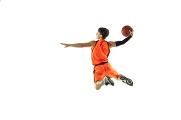 Young basketball player of team wearing sportwear training, practicing in action, motion in jump,...