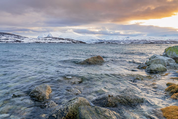 winter landscape at polar dawn on Kvaløya Island and fjord near Tromso, northern Norway