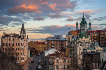 Fototapeta premium View to Old District Podil of Kyiv city from Zamkova Hill at sunset.