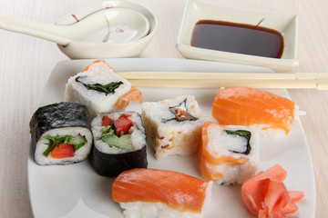 Sushi and rolls with porcelain sauce