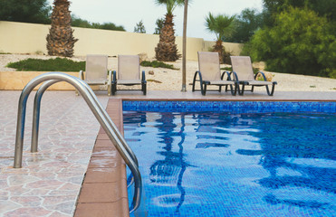 Outdoor swimming pool at summer time.