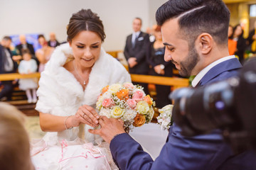  Bride and groom during wedding ceremony in church.