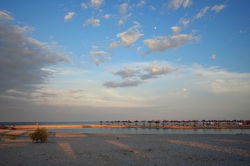 Evening seascape with beach umbrellas