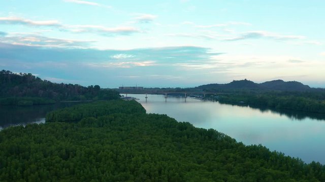 Aerial footage of Beautiful Rural village landscape with green forest in surrounding in Mengkabong River, Tuaran, Sabah, Borneo