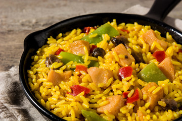 Fried rice with chicken and vegetables on frying iron pan