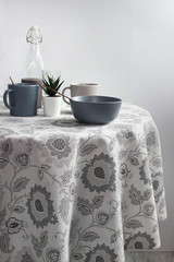 gray ceramic bowl on the table with a gray tablecloth