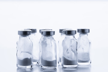 Antibiotic. A row of glass medical vaccine bottles.