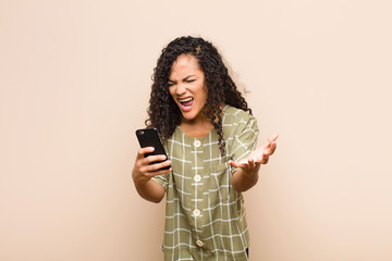 young black woman looking angry, annoyed and frustrated screaming wtf or what‚Äôs wrong with...
