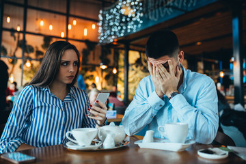 young couple in restaurant arguing, relationship problems