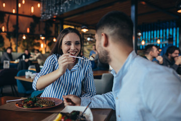 young romantic couple having lunch in restaurant.