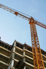 Crane. Self-erection crane over construction site. Crane near bulding.