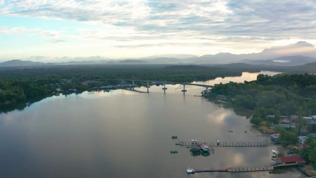 Aerial footage of Beautiful Rural village landscape with green forest in surrounding in Mengkabong River, Tuaran, Sabah, Borneo