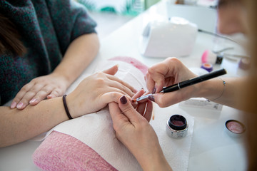 Obraz na płótnie Canvas Manicure process in beauty salon - woman hand nails care.