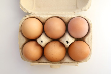 Pack of six free range eggs on white background. Top view.