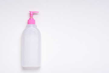 empty white bottle with pink lid and dispenser on white background for branding