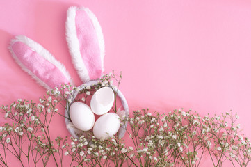Happy Easter. Flat Lay of easter ears and gypsophila flowers on a pink background. Easter...