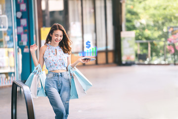 Beautiful smile asian young woman happy relax shopping on sale season.