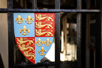 Colorful coat of arms on iron gate in small village in England