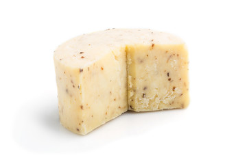 Piece of cheddar cheese isolated on white background. Side view.