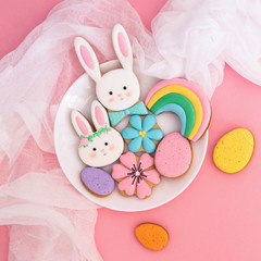 Happy Easter. Multi-colored pastel easter cookies on a pink background. 