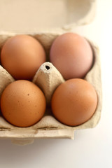 Free range eggs and gypsophila flowers on white background. Selective focus.