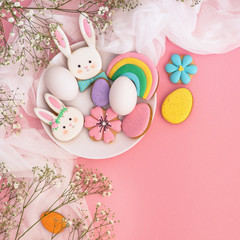 Happy Easter. Multi-colored pastel easter cookies on a pink background. 