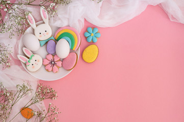 Happy Easter. Multi-colored pastel easter cookies on a pink background. 
