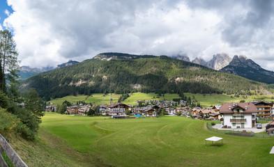Large panoramic view of Pozza di Fassa, a commune in Trentino at the northern Italia