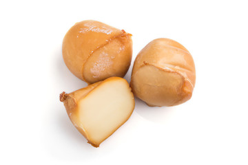 Piece of smoked cheese isolated on white background. Side view.