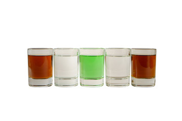 Multicolored transparent cocktails, a set of shots in one row, five servings. Side view Isolated white background. Drink for the menu restaurant, bar, cafe