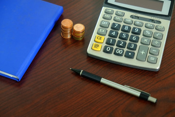 finance business background with calculator pen money and paperwork on desk for accounting and analyzing investment at office work space. banking , savings , accountant , finances and economy concept.