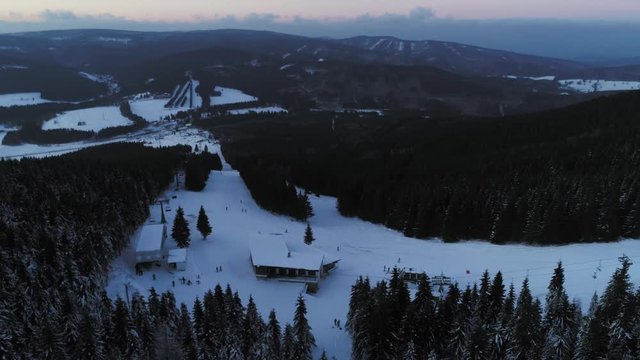 The beautiful snow covered Ramzov&aacute; ski touring resort with the &Scaron;er&aacute;k mountain in the distance - aerial