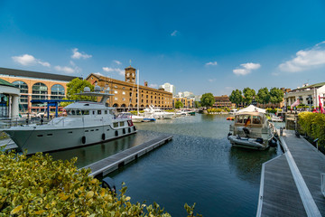St Katharine Docks Marina Wharf near Tower Bridge in London with some ships and historic sailing...