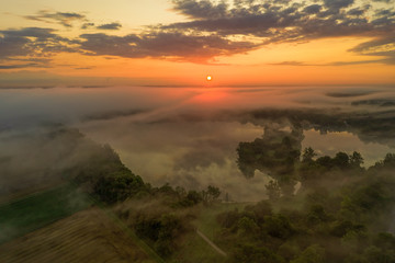 Impressive sunrise over a foggy lake, pure nature moment.