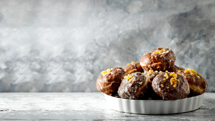 Fresh donuts on dark mood background and copy space for your decoration.Fat Thursday time in Poland.