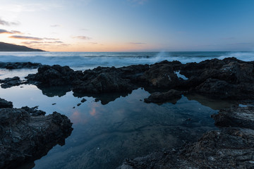 sunset over the sea at ninety mile beach in ahipara