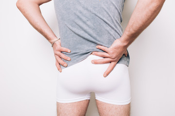 athletic male butt in white boxers. men's health problems: hemorrhoids, prostatitis. disease...