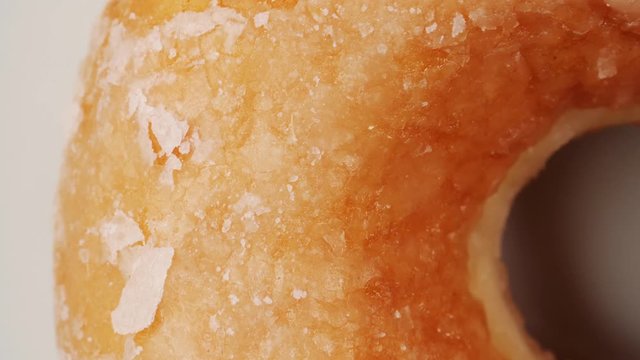 Top view of the side of a donut rotating on a table. Closeup