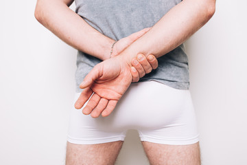 athletic male butt in white boxers. men's health problems: hemorrhoids, prostatitis. disease...