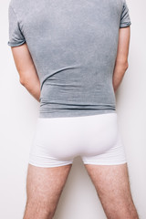 athletic male butt in white boxers. men's health problems: hemorrhoids, prostatitis. disease...