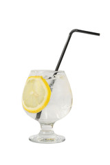 Transparent cocktail, refreshing water in a low glass with ice cubes, straw, and a round slice of lemon, side view, isolated white background. Drink for the menu restaurant, bar, cafe