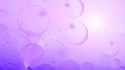 bright oily drops in water with colorful background, close-up 