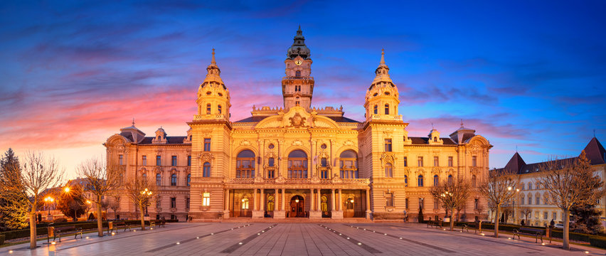 Gyor, Hungary. Panoramic cityscape image of Gyor downtown with Gyor Town Hall during beautiful sunrise.