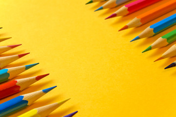 Set of sharpened colored pencils on a yellow background       