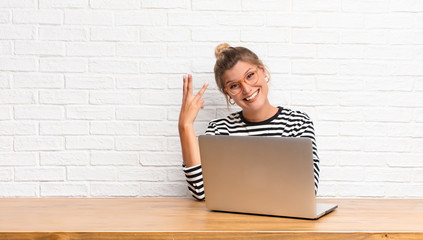  smiling and looking friendly, showing number three or third with hand forward, counting down