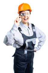 girl construction engineer examines something in a magnifying glass. Isolated