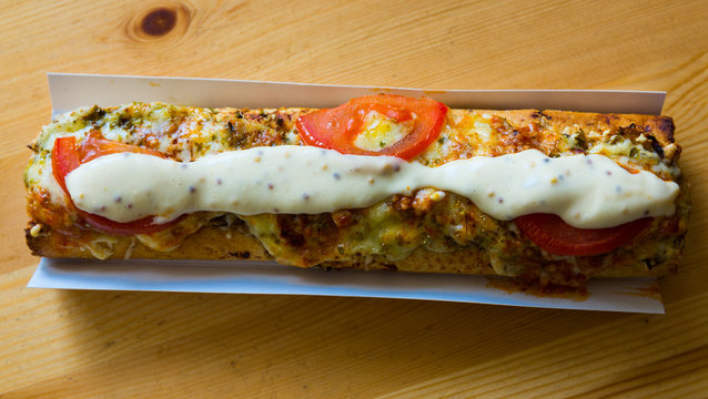 Polish zapiekanka toasted baguette with cheese and vegetables