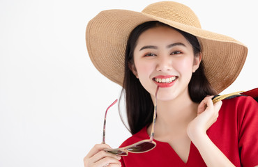 Portrait of young beautiful asian girl wearing red dress and sun hat and sunglasses holding...